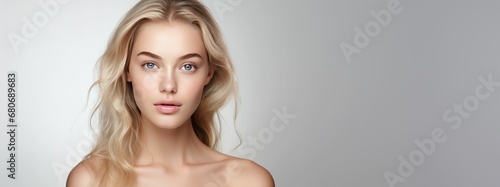 Photo of a female model with clear and healthy skin on a studio background. © Royal Ability