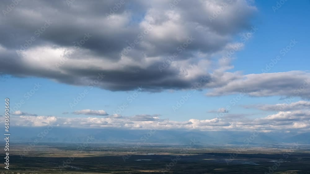 Flying clouds bird's eye view over the valley on a sunny day, 4k, timelapse Flying clouds bird's eye view over the valley on a sunny day, 4k, timelapse