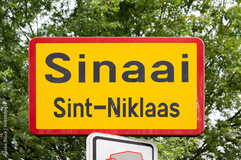 Sinaai, East Flemish Region, Belgium - Yellow road sign of the village and municipality of Sinaai, Sint-Niklaas Sinaai, East Flemish Region, Belgium - Yellow road sign of the village and municipality of Sinaai, Sint-Niklaas