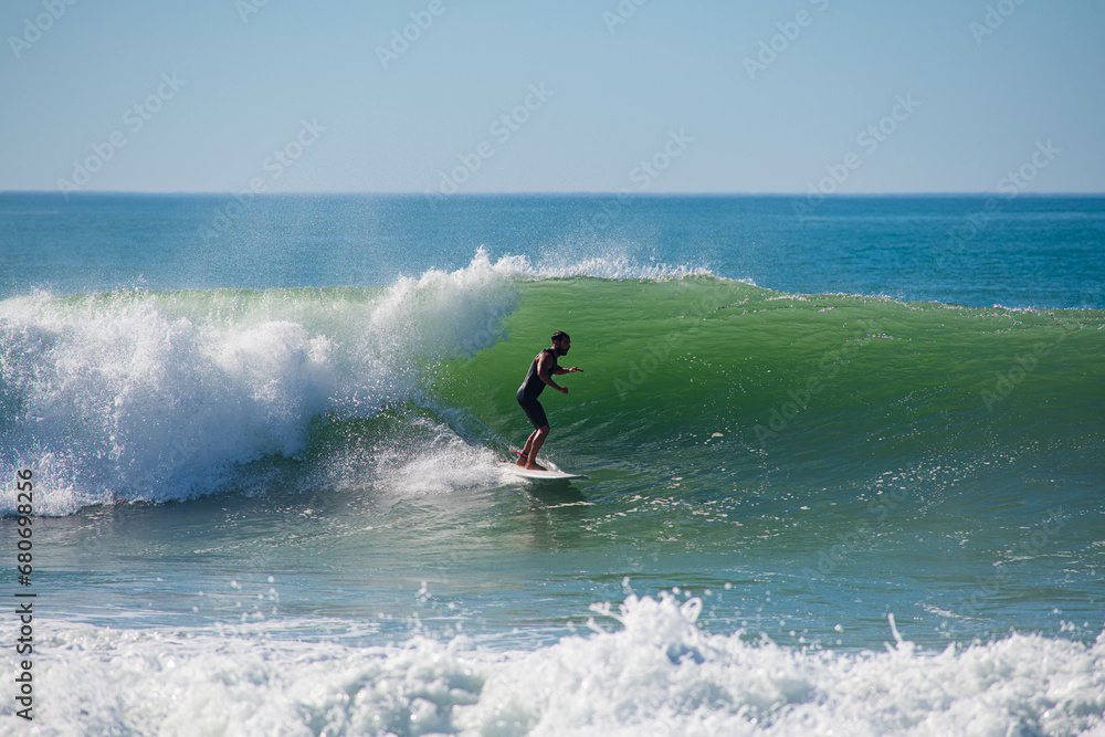 Surfer in action in the tubular waves of the Atlantic Ocean Surfer in action in the tubular waves of the Atlantic Ocean