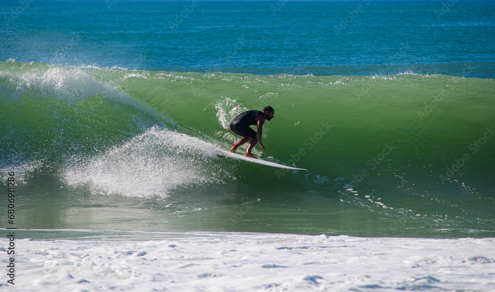 Surfer in action in the tubular waves of the Atlantic Ocean Surfer in action in the tubular waves of the Atlantic Ocean