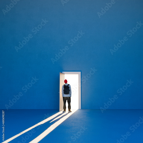 Door open on a large wall and a man backlit in the doorway. Life choices, making decisions, following your own path, having the courage to change. 3d rendering photo