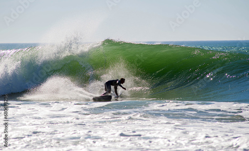Surfer in action in the tubular waves of the Atlantic Ocean