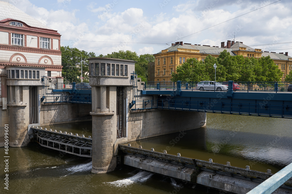 Fototapeta premium Hradec Kralove, Czech Republic - July 22, 2023 - the Moravian weir with hydroelectric power plant in the middle of summer 