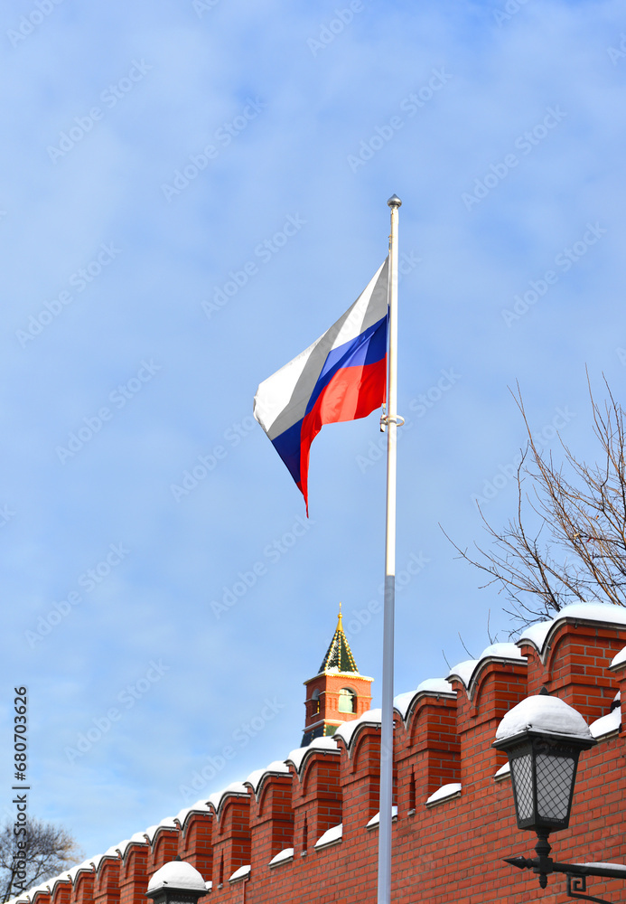 Flag of Russian Federation against background of Kremlin wall in winter. Moscow, Russia