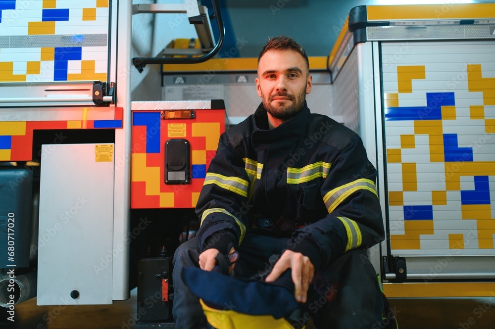 Fototapeta premium Portrait of male firefighter in uniform at fire station