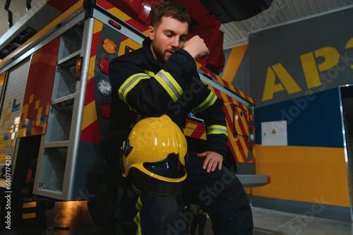 depressed and tired firefighter near fire truck