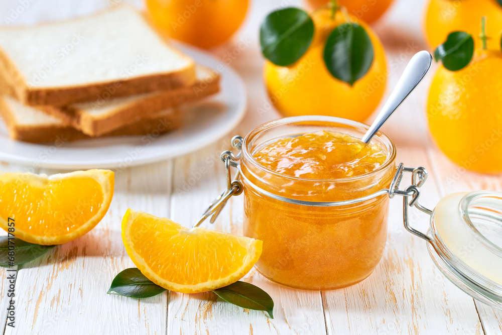 Plate with slices of bread and delicious orange jam on wooden table. Bread and orange homemade jam on wooden table. Plate with slices of bread and delicious orange jam on wooden table. Bread and orange homemade jam on wooden table.