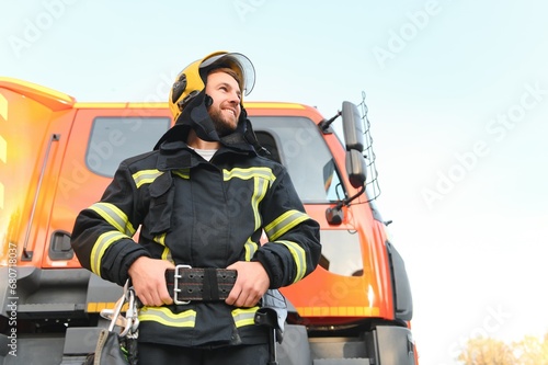 Photo of fireman with gas mask and helmet near fire engine © Serhii