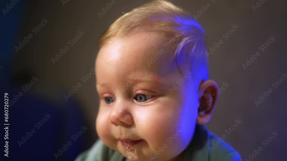 Adorable face of a little baby with big eyes and blond hair. Close up portrait with cute plump cheeks. Close up. Adorable face of a little baby with big eyes and blond hair. Close up portrait with cute plump cheeks. Close up.