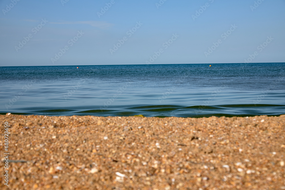 view of the blue black sea from the beach, summer, wind, creates drawings on the sand. lots of shells view of the blue black sea from the beach, summer, wind, creates drawings on the sand. lots of shells