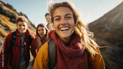 Close up photo of several students or happy young people hiking high in the mountains in daylight
