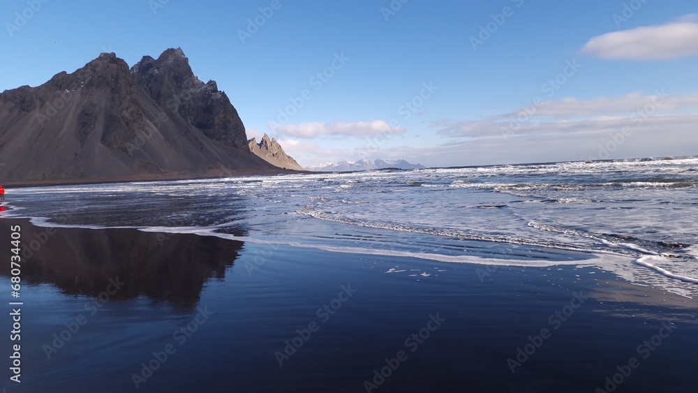 Towering arctic vestrahorn mountains, icelandic amazing environment on peninsula of Stokksnes. Overview of massive frosty nordic landscape with lovely black sand beach in Iceland.