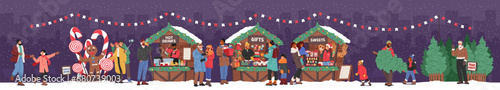 People Gather At Christmas Fair, Amidst The Twinkling Lights, Browsing Stalls, Posing At The Festive Photo Zone