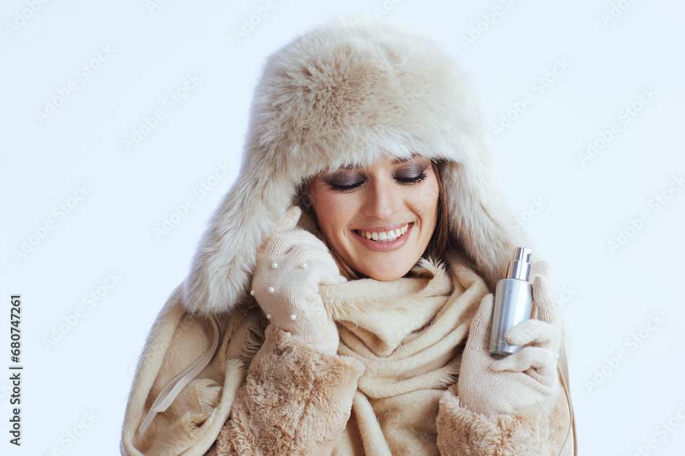 smiling stylish woman in winter coat and fur hat on white smiling stylish woman in winter coat and fur hat on white