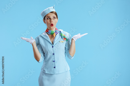 surprised elegant air hostess woman on blue
