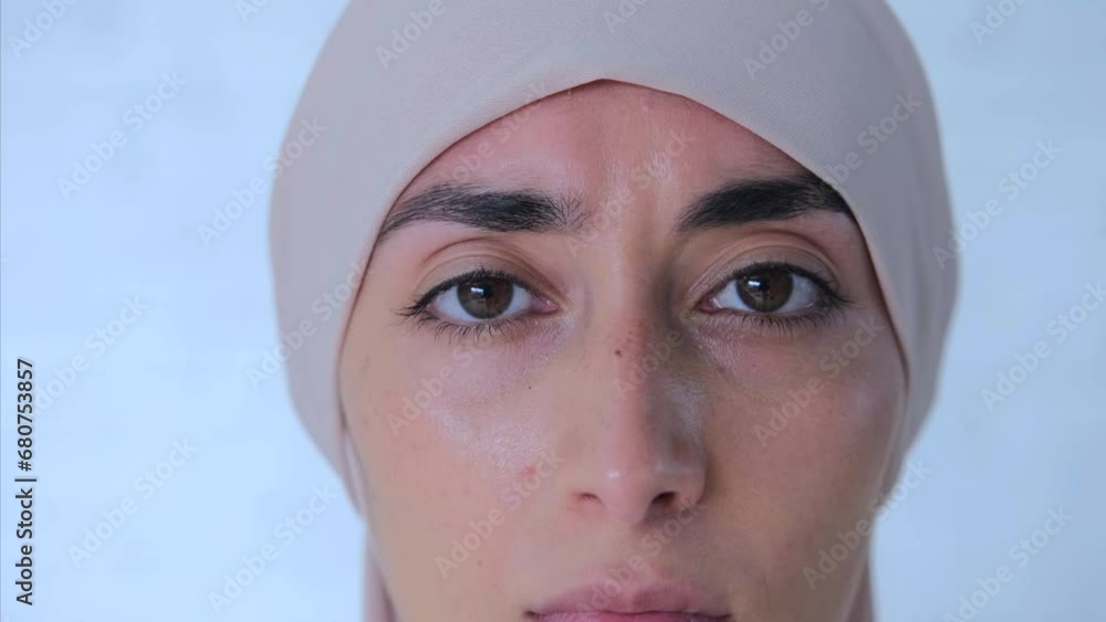 Approaching shot to Muslim sad eyes that crying for help. Close-up of Muslim woman in bright hijab with sad eyes feels infringement of one's rights. Stop infringe rights of Muslim women, make them sad Approaching shot to Muslim sad eyes that crying for help. Close-up of Muslim woman in bright hijab with sad eyes feels infringement of one's rights. Stop infringe rights of Muslim women, make them sad