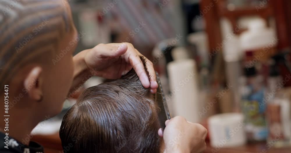 Soft focus Hairdresser cuts hair, combs it. Stylish boy sitting in a hairdresser. Barber man cuts hair of cute little boy child. Attractive man getting his hair cut in a modern barbershop. 4K Soft focus Hairdresser cuts hair, combs it. Stylish boy sitting in a hairdresser. Barber man cuts hair of cute little boy child. Attractive man getting his hair cut in a modern barbershop. 4K