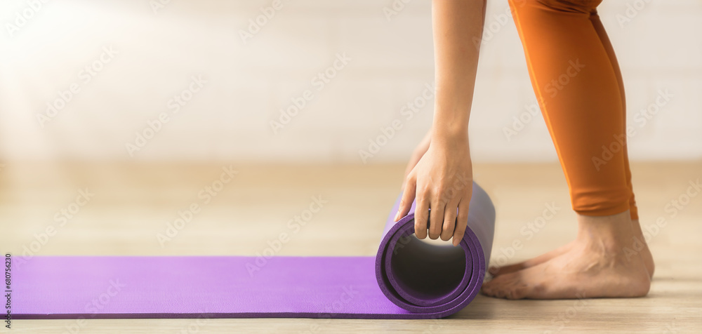 Rolling up a yoga mat post-practice