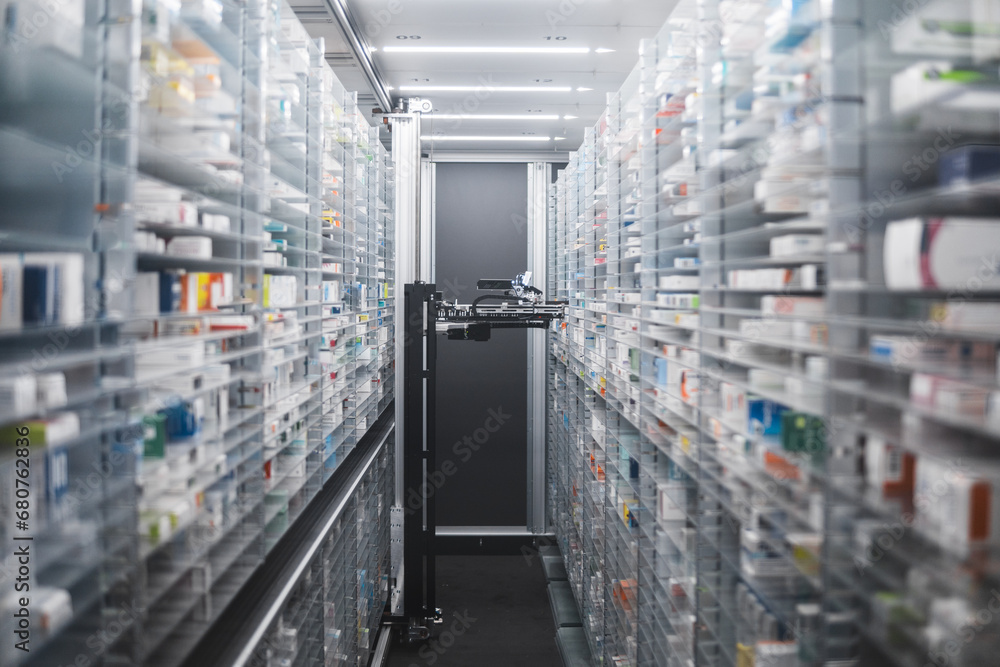 Narrow pharmacy aisle flanked by towering shelves stocked with medicine boxes. A pharmacy robot navigates through, ensuring efficient and precise medication retrieval. - obrazy, fototapety, plakaty 