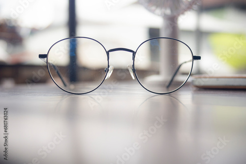 Eyeglasses on the table in a coffee shop, stock photo