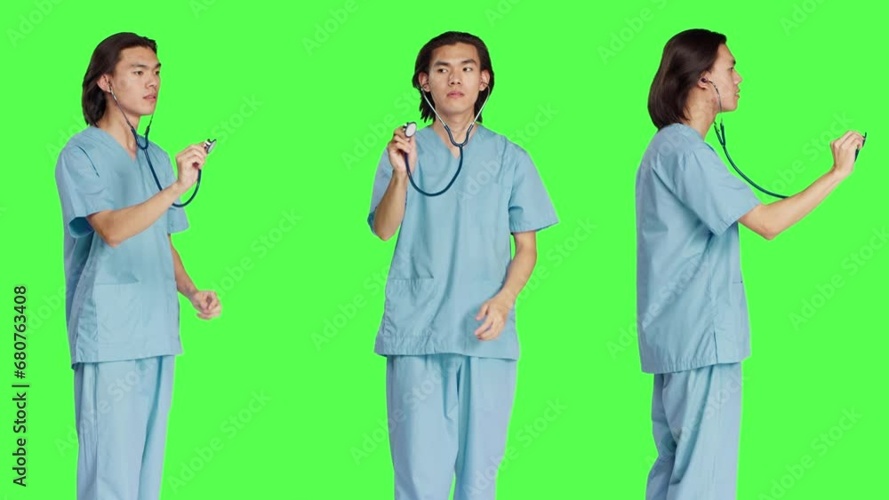 Medic preparing for wellness examination at clinic using stethoscope and wearing medical attire. Asian healthcare assistant holding checkup tool against greenscreen background. Medic preparing for wellness examination at clinic using stethoscope and wearing medical attire. Asian healthcare assistant holding checkup tool against greenscreen background.