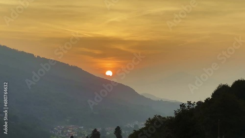 Beautiful Sunset over Mountain Valley and Mountain Range in Malcantone, Ticino, Switzerland, Europe photo