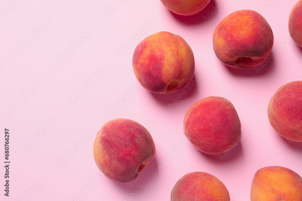 Many whole fresh ripe peaches on pink background, flat lay. Space for text Many whole fresh ripe peaches on pink background, flat lay. Space for text