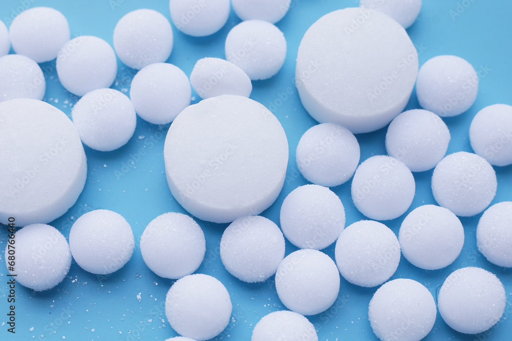 White mothballs on blue background. White mothballs on blue background.
