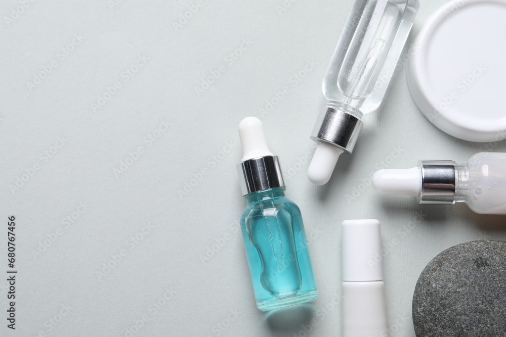 Flat lay composition with cosmetic serum on light grey background. Space for text Flat lay composition with cosmetic serum on light grey background. Space for text