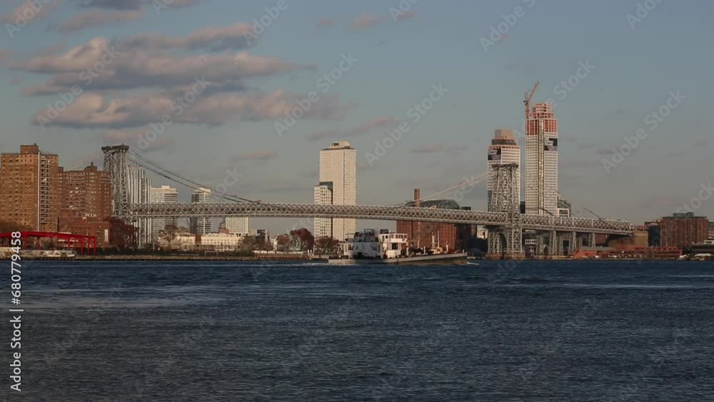barge passing in front of the williamsburg bridge (between manhattan and brooklyn on the nyc hudson river waterfront) boat, water, skyline, barge passing in front of the williamsburg bridge (between manhattan and brooklyn on the nyc hudson river waterfront) boat, water, skyline,