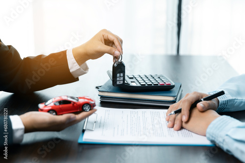 Toy Car In Front Of Businessman Calculating Loan. Saving money for car concept, trade car for cash concept, loan finance concept.