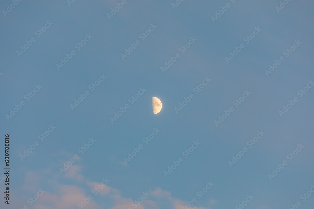 The moon floating in the sunset sky. The moon floating in the sunset sky.