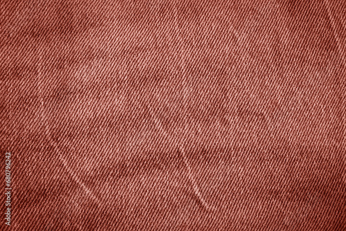 Texture of crumpled red jeans. 