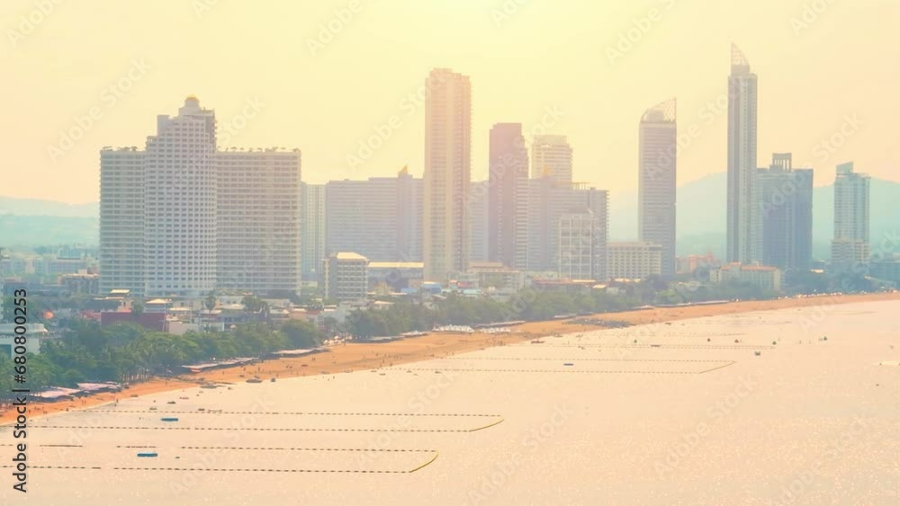 Evening Splendor: As the sun dips below the horizon, Jomtien Beach transforms into a captivating canvas of vibrant oranges, casting a spellbinding spell. Pattaya, Thailand. Aerial view drone.
Evening Splendor: As the sun dips below the horizon, Jomtien Beach transforms into a captivating canvas of vibrant oranges, casting a spellbinding spell. Pattaya, Thailand. Aerial view drone.
