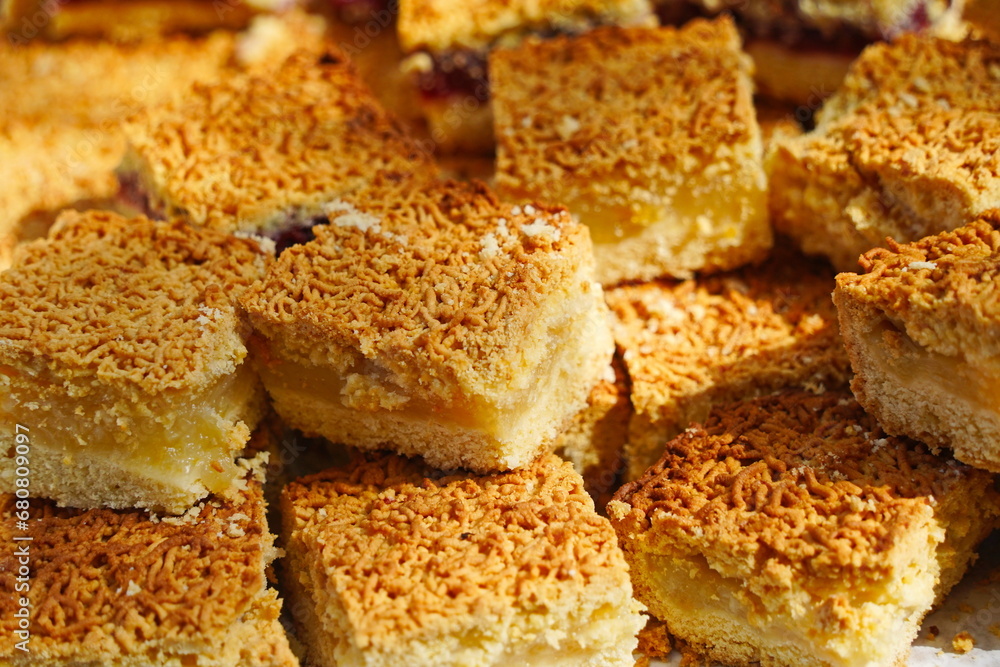 Slices of sweet pie with filling on the table.