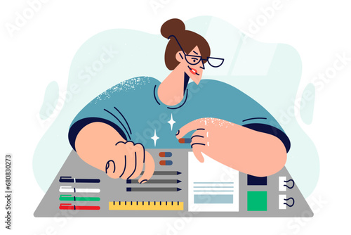 Perfectionist woman with ocd lays out stationery items on table, experiencing psychological distress