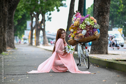 Canvastavla A young girl wearing a lotus pink color ao dai the traditional costume of Vietnam