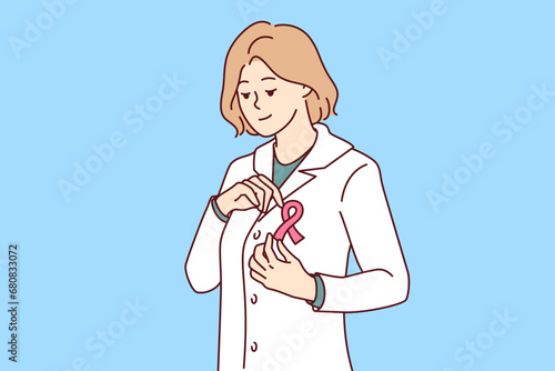 Woman doctor calls for fight against breast cancer by putting pink ribbon on robe. Girl medic expresses solidarity with people suffering from breast cancer and oncological diseases