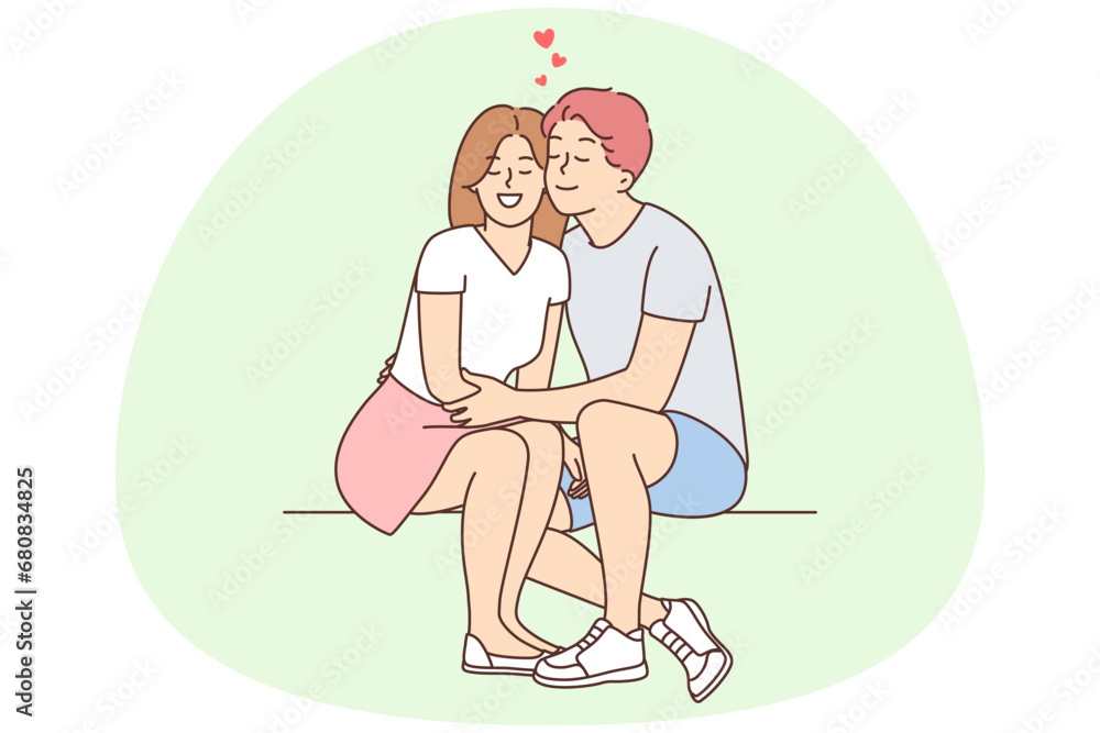 Happy couple sit outside hugging Happy couple sit outside hugging