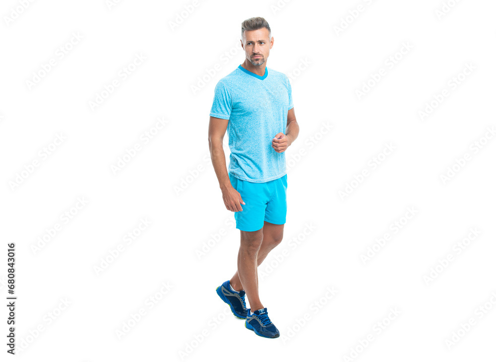 runner sport man walk isolated on white background. Athletic mature sport man standing. Sport man standing wearing gym sportswear. Handsome sport man after workout in studio runner sport man walk isolated on white background. Athletic mature sport man standing. Sport man standing wearing gym sportswear. Handsome sport man after workout in studio