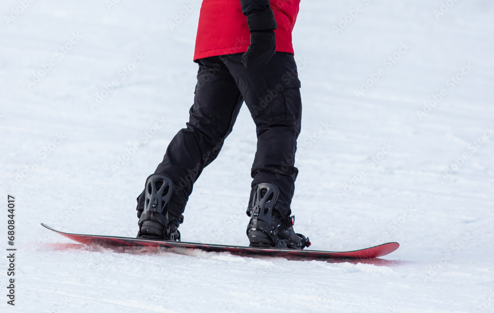 A man snowboards in the snow in winter A man snowboards in the snow in winter