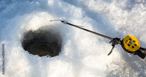 Fototapeta Naklejka Na Ścianę i Meble -  Fishing rod on ice in winter. Ice fishing