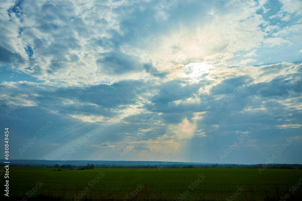 Landscape with the texture of clouds closer to sunset. The rays of the sun through the clouds. The nature of the central part of Eurasia. Landscape with the texture of clouds closer to sunset. The rays of the sun through the clouds. The nature of the central part of Eurasia.