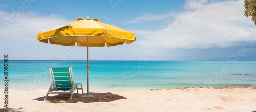 Beach chair with umbrella and beautiful tropical sand beach and blue sea. © is