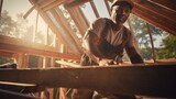 A middle-aged man is building a house, working on the roof. Work and profession, construction and installation.
