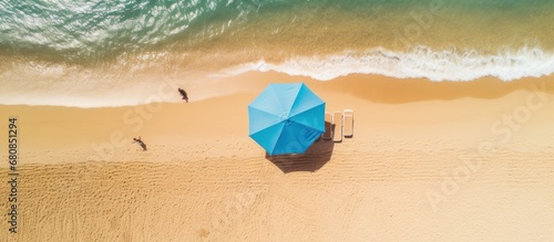 Top view an umbrella and beautiful tropical sand beach and blue sea.