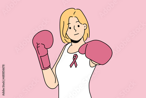 Woman fights cancerous tumor using boxing gloves and resisting development cancer. Boxer girl with pink ribbon symbolizing fight against breast cancer and promoting early detection symptoms disease