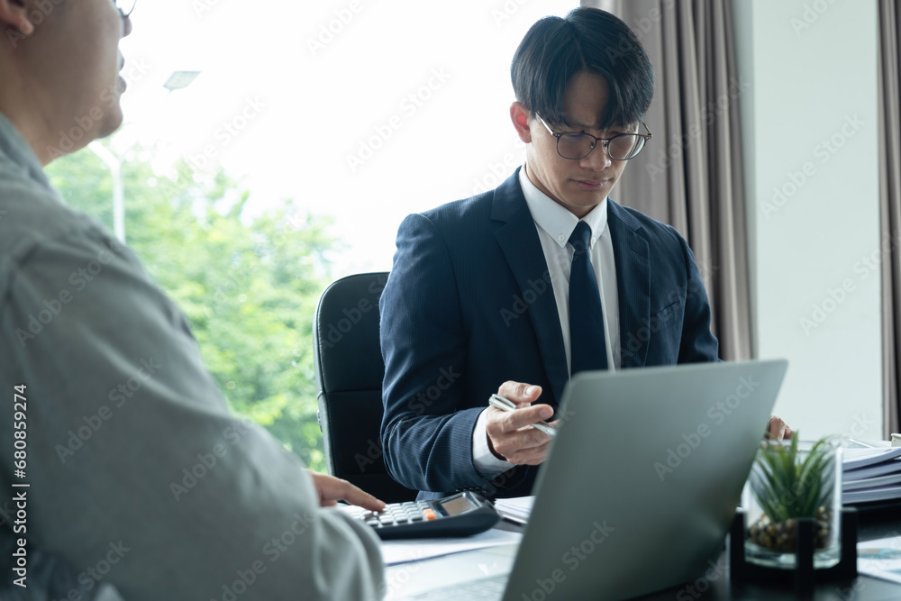 Businessmen working together at desk. Businessmen working together at desk.