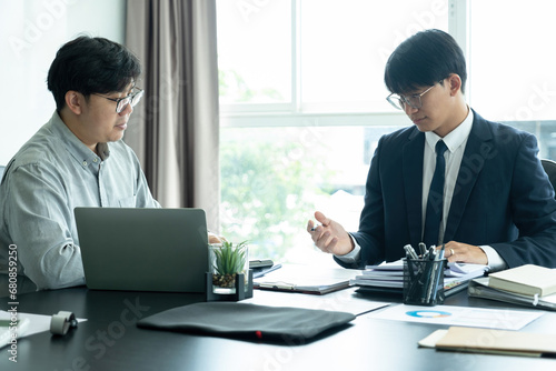 Businessmen working together at desk.